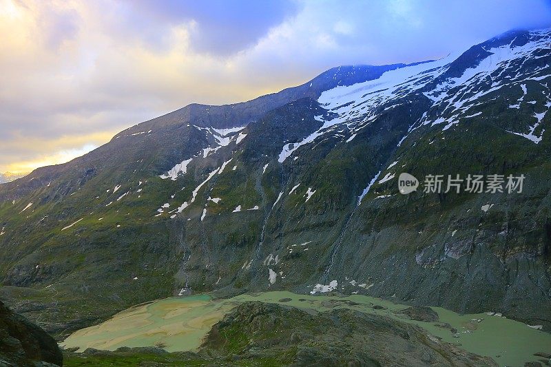 冰川湖和Hohe Tauern雪顶奥地利山脉-泰洛阿尔卑斯戏剧性的云景天空和景观和大格洛克纳山脉